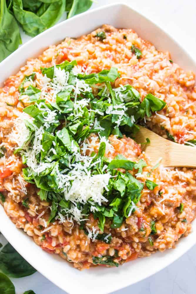 overhead shot tomato Sausage Risotto topped with basil