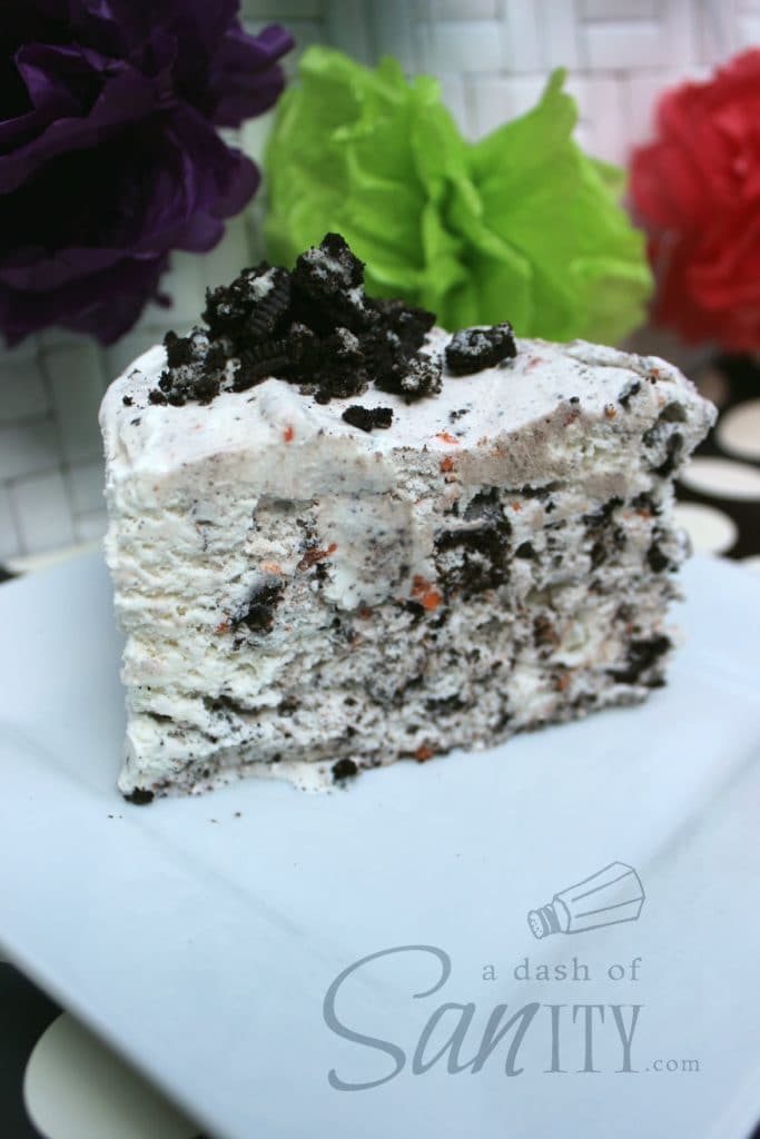 Oreo Ice Cream Cake slice on a square plate topped with crumbled oreos