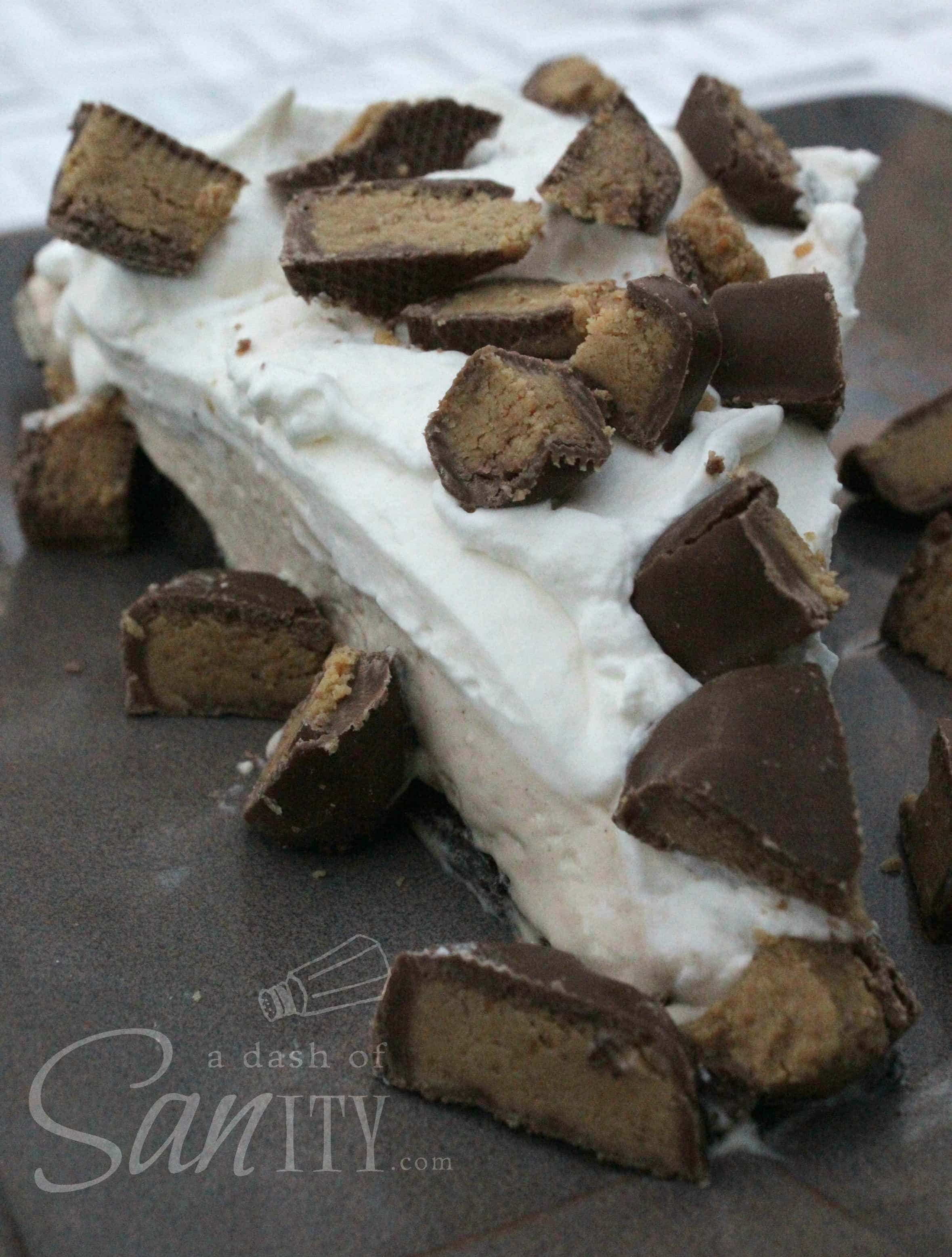 Easy Peanut Butter Pie slice topped with chopped peanut butter cups served on a plate
