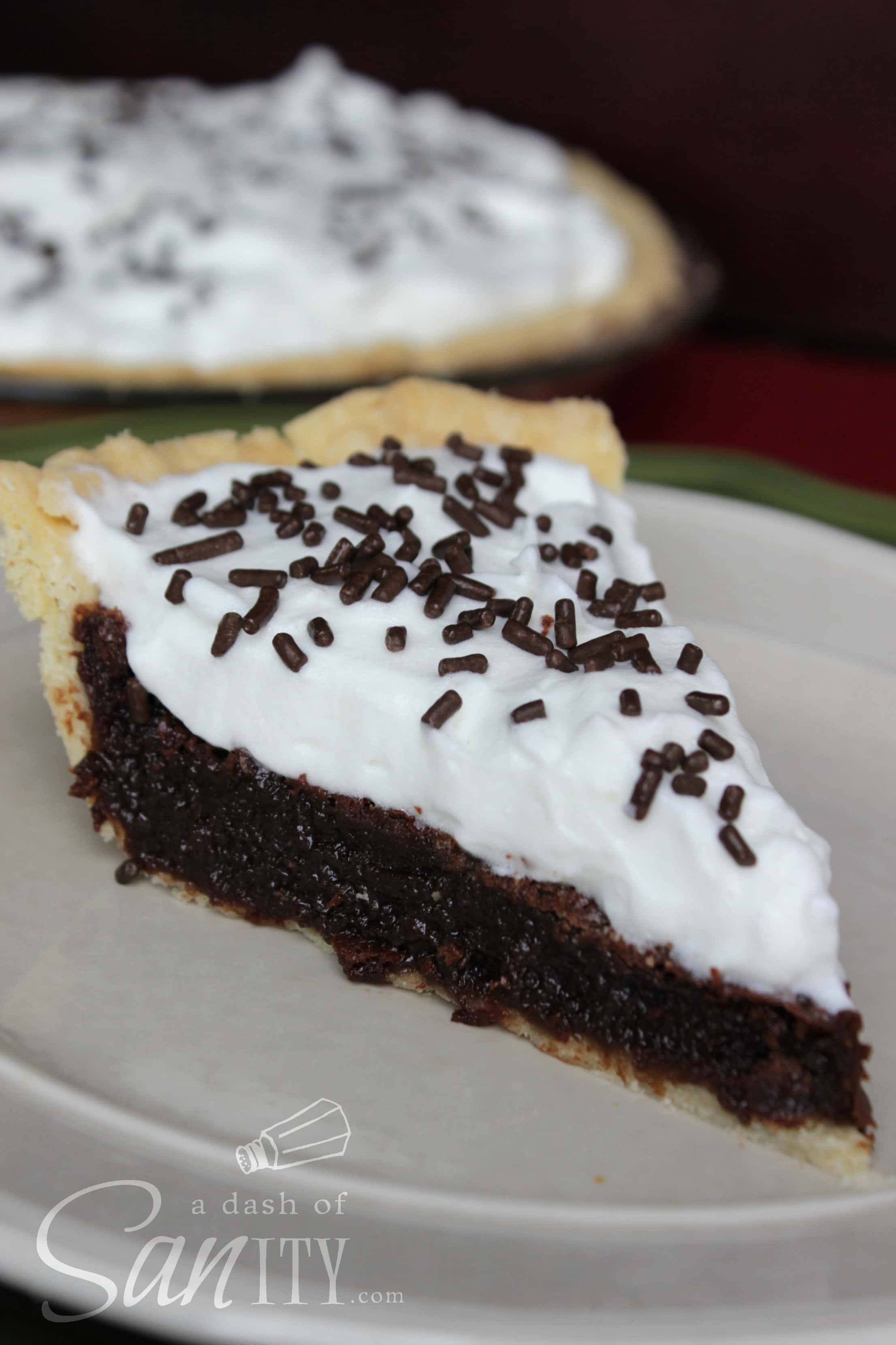 Rich Fudge Pie slice served on a plate, topped with chocolate sprinkles