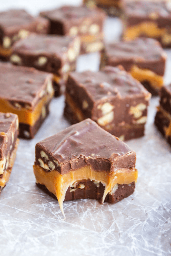 Caramel Pecan Turtle Fudge with bite taken out of it.