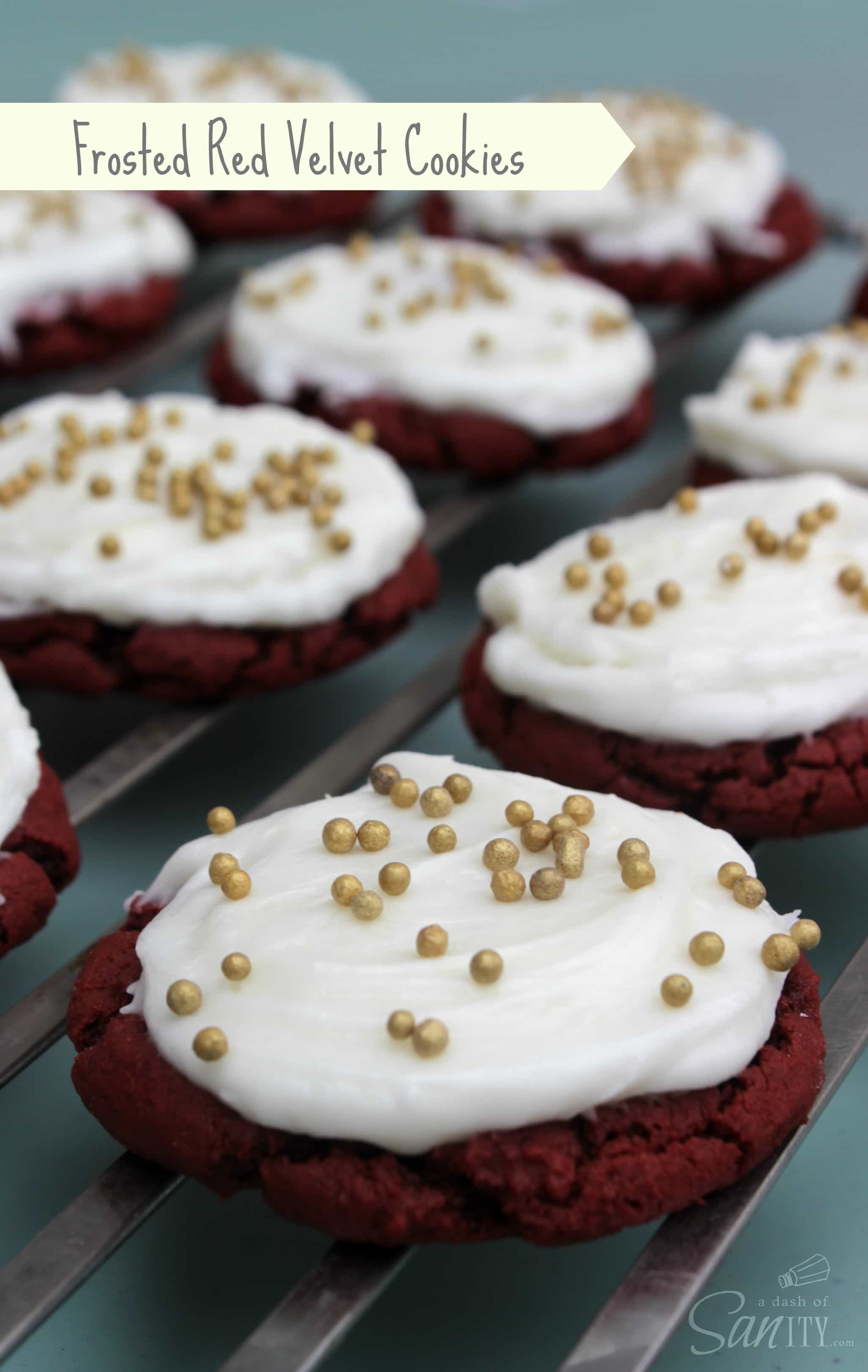 These Red Velvet Cookies are a soft and chewy chocolate cookie topped with a light and fluffy cream cheese buttercream frosting. Red Velvet Cookies iced with gold sprinkles on a metal cooling rack