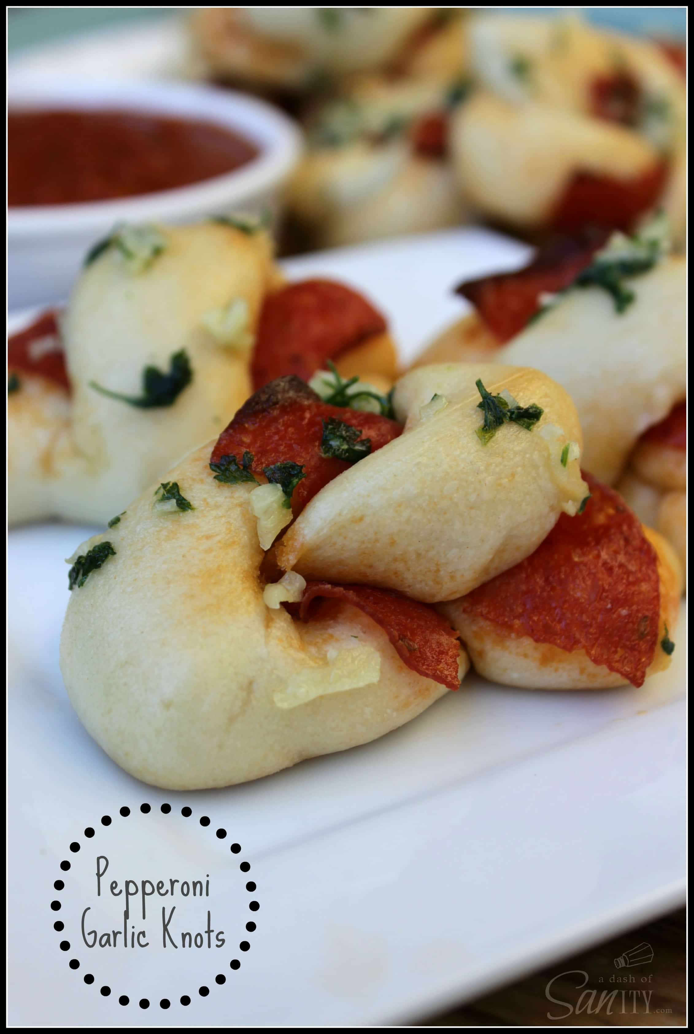Pepperoni Garlic Knots served on a plate with Homemade Marinara in a dipping bowl
