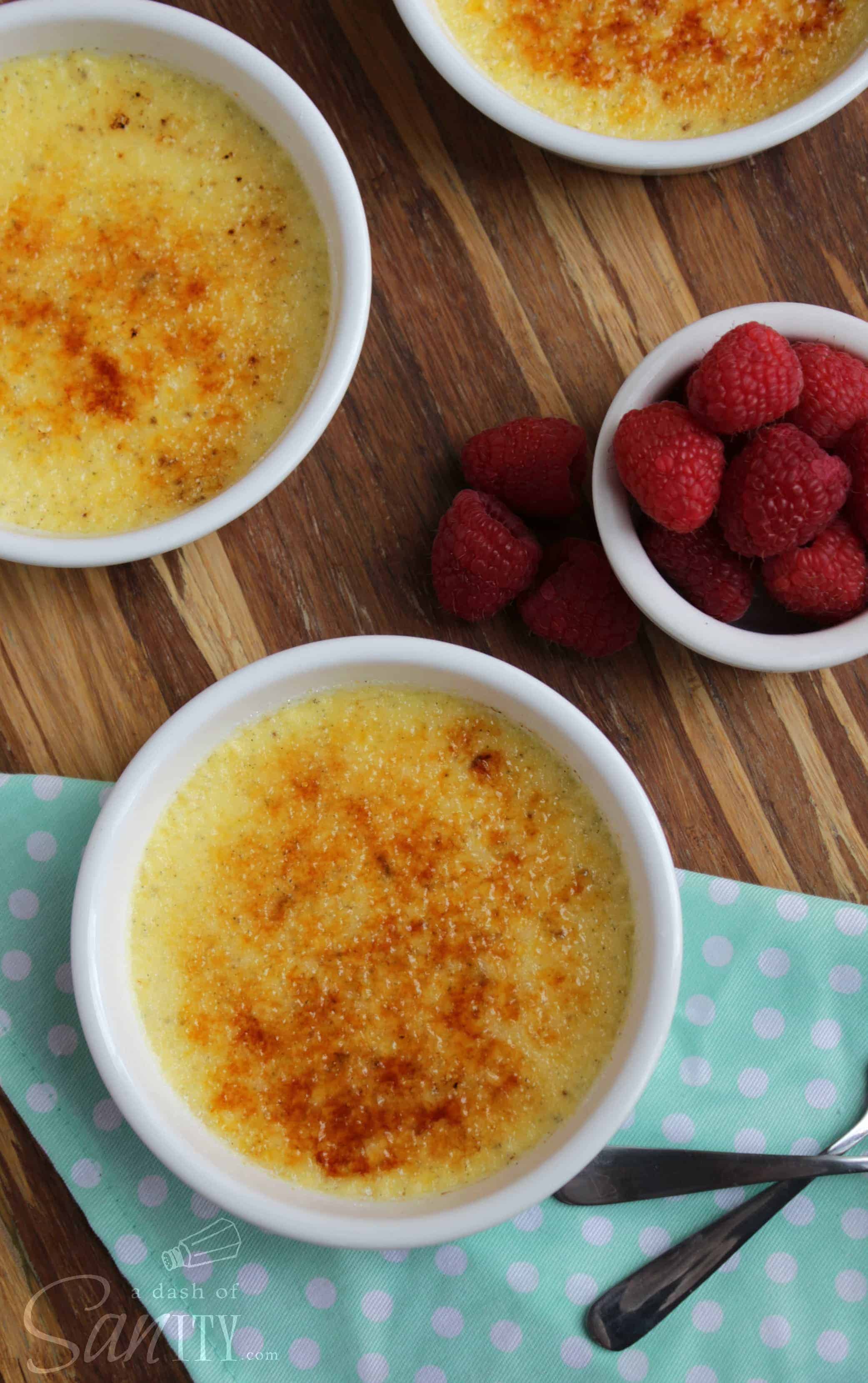 Vanilla-Bean Almond Crème Brûlée, 3 brulees with a bowl of raspberries