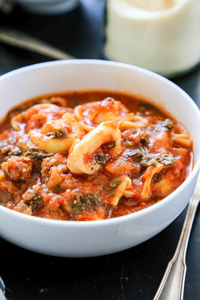 Tuscan Tortellini Soup delicious and comforting. Made with tomatoes, Italian sausage, garlic, onions, kale, and parmesan cheese; you love this simple meal. tortellini soup in bowl
