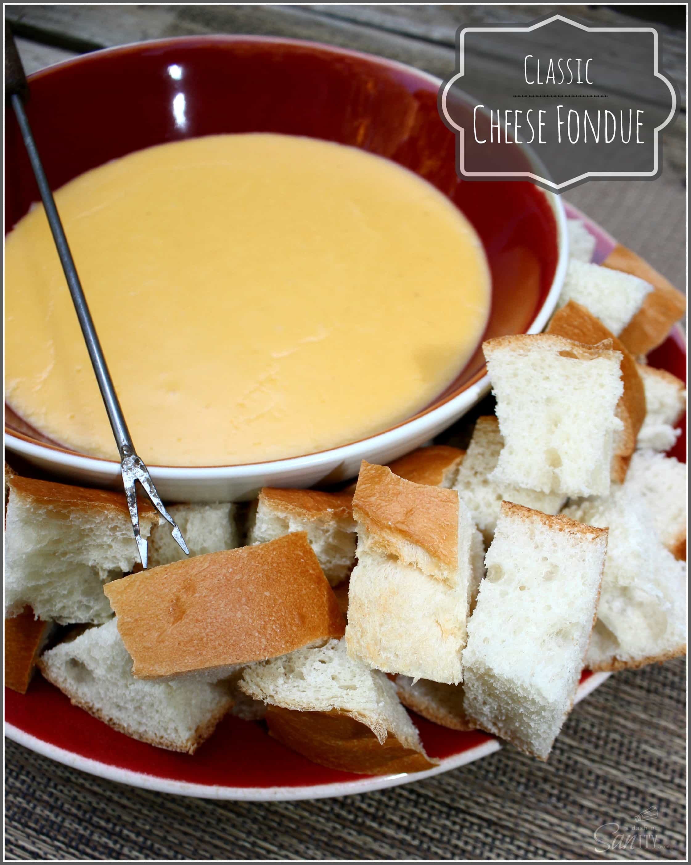 Cheese Fondue in a bowl served on a plate of bread cubes, with a fondue fork