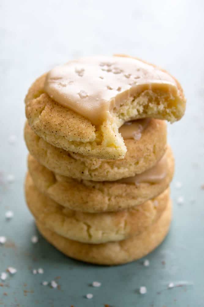 photo of a stack of 5 White Chocolate Caramel Snickerdoodles, top one has a bite taken out of it