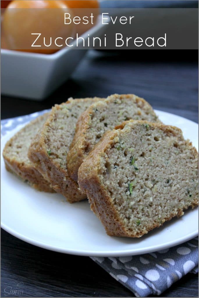 BEST EVER ZUCCHINI BREAD four slices on a white plate with apples in the background