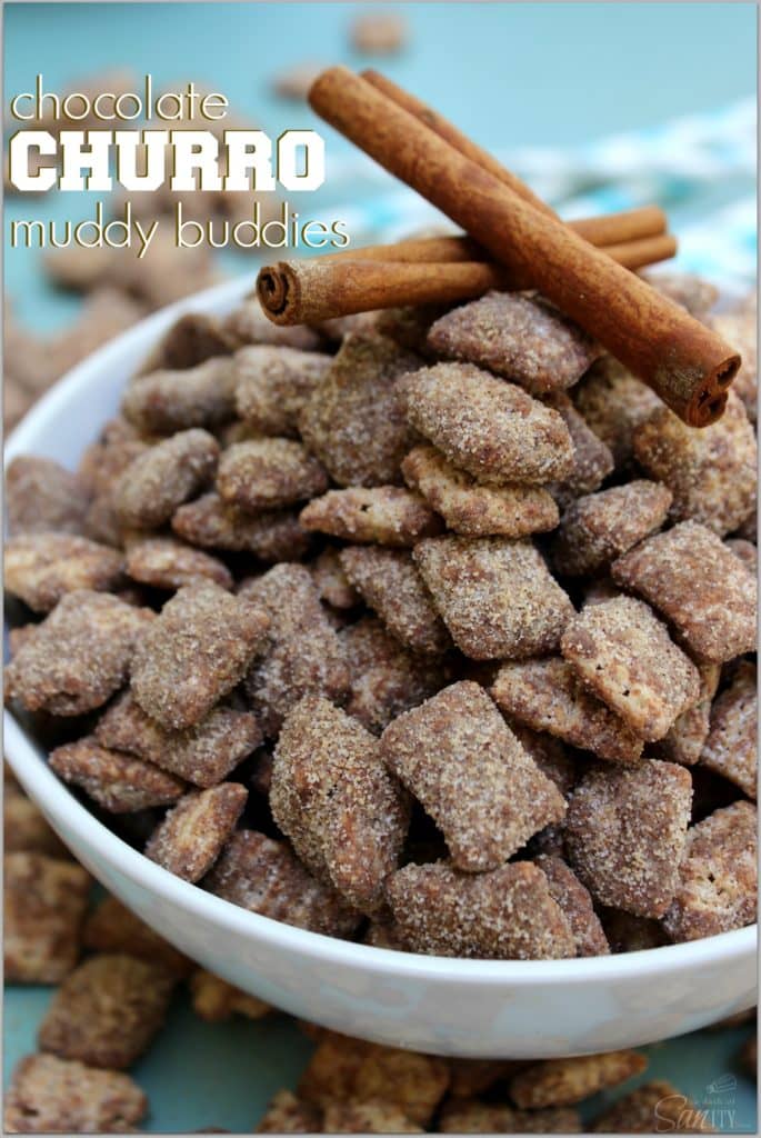 CHOCOLATE CHURRO MUDDY BUDDIES - a collision of your classic Muddy Buddies & churros making the best cinnamon & sugar bite sized treat. Old photo of chocolate churro muddy buddies in a white bowl with two cinnamon sticks on top