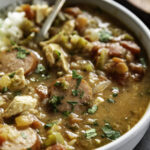 close up shot of gumbo in bowl with rice