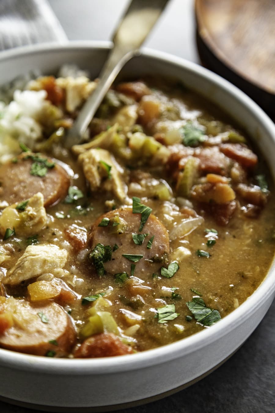 close up shot of gumbo in bowl with rice