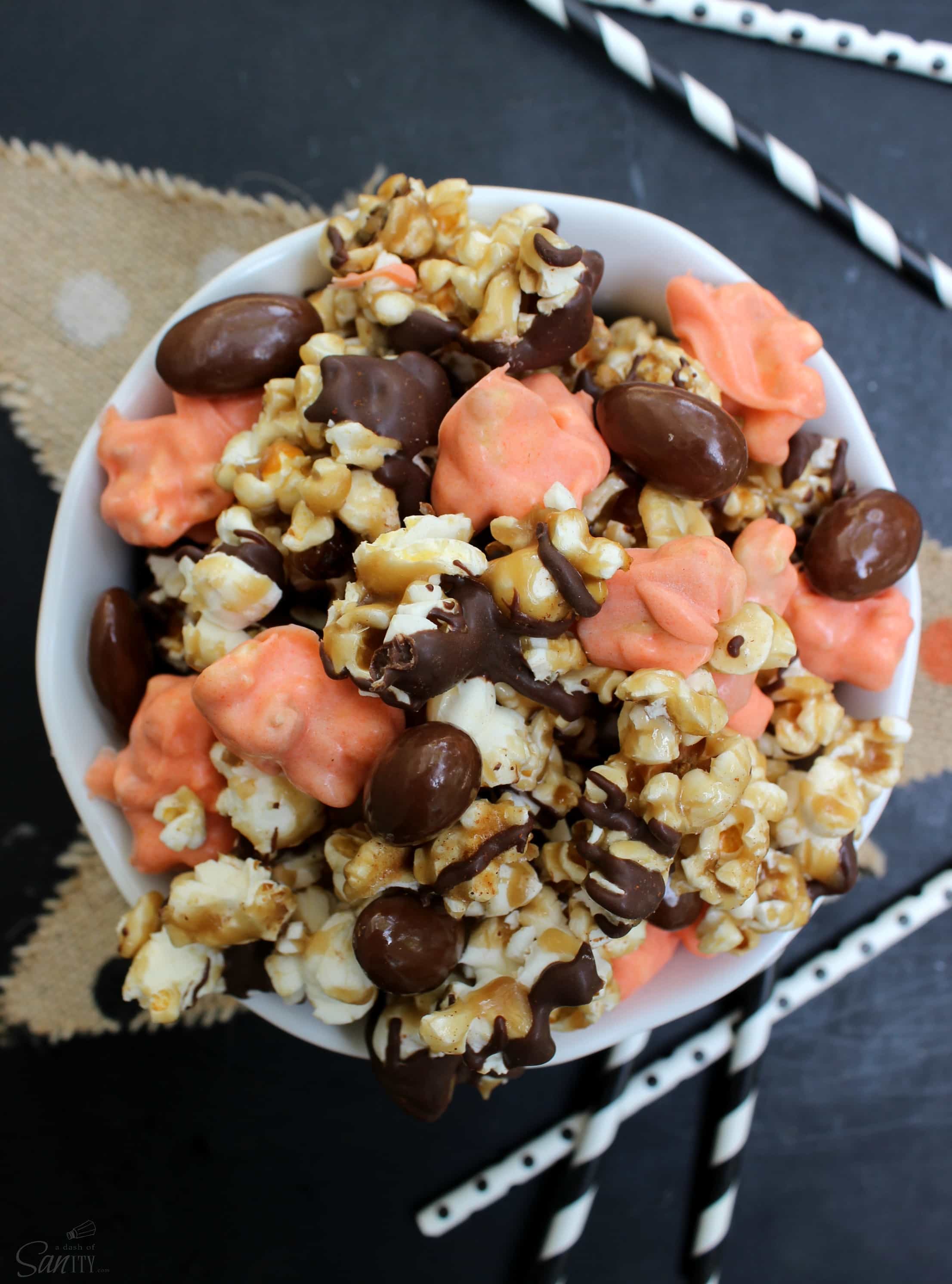 This Caramel Pumpkin Crunch is festive & delicious. Made with Amish Caramel Corn, chocolate covered almonds, dark chocolate, and cinnamon swirls.