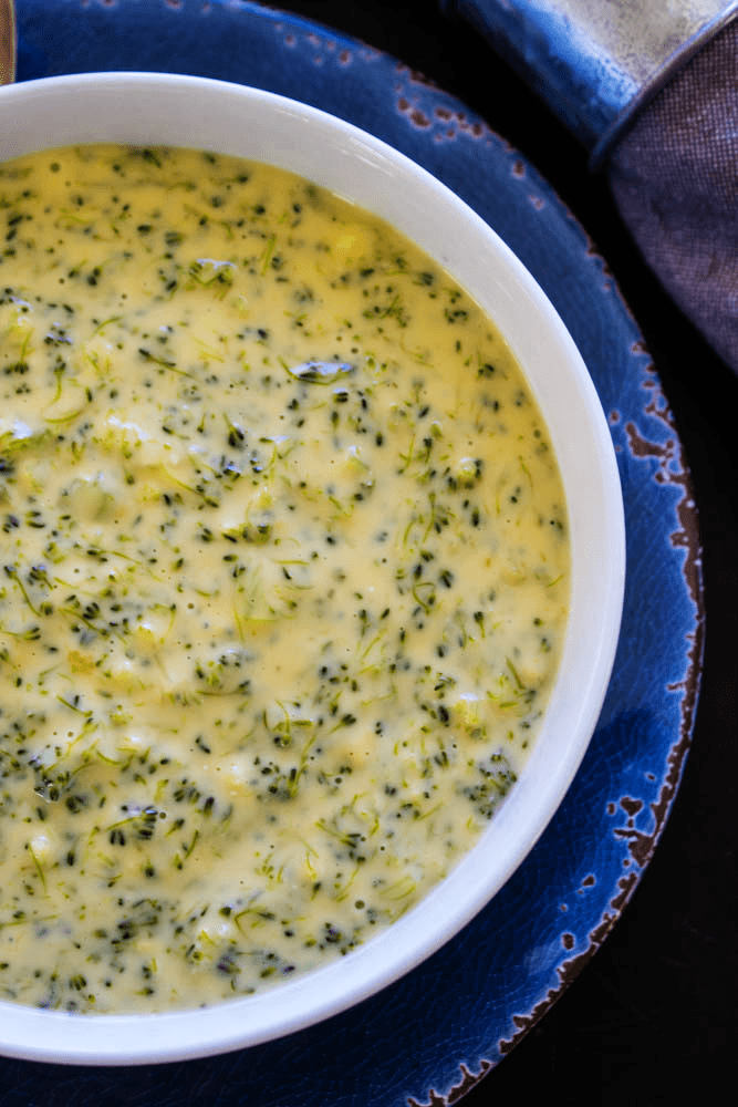 overhead shot Broccoli Cheese Soup served in a white bowl