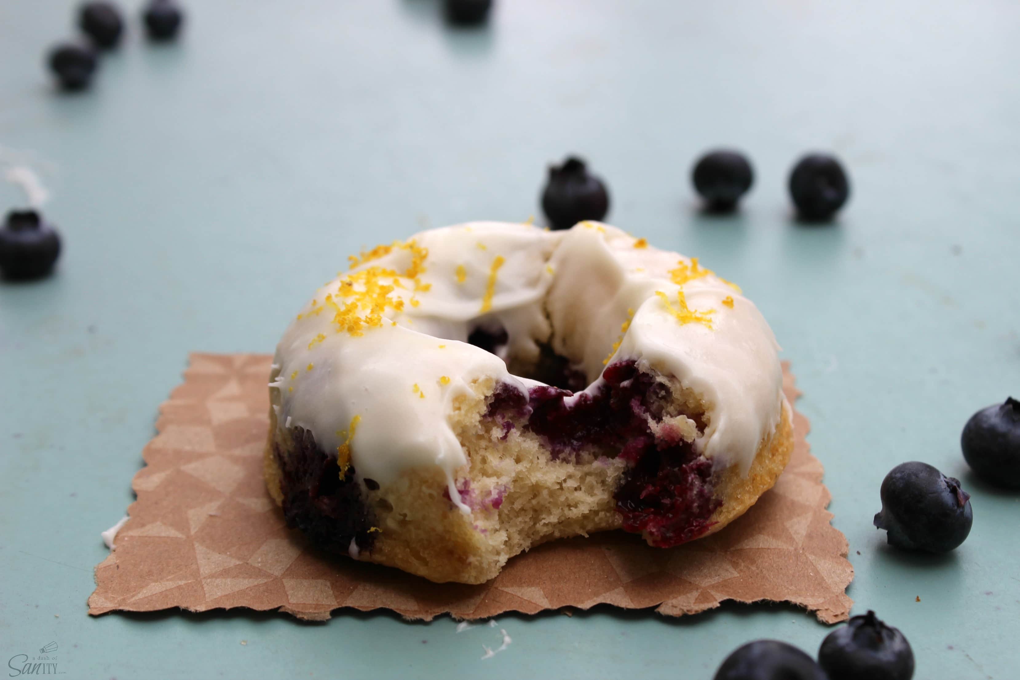 These Baked Blueberry Cake Donuts are just amazing! Topped with a cream cheese and lemon zest frosting, these cake donuts make a delightful baked treat.