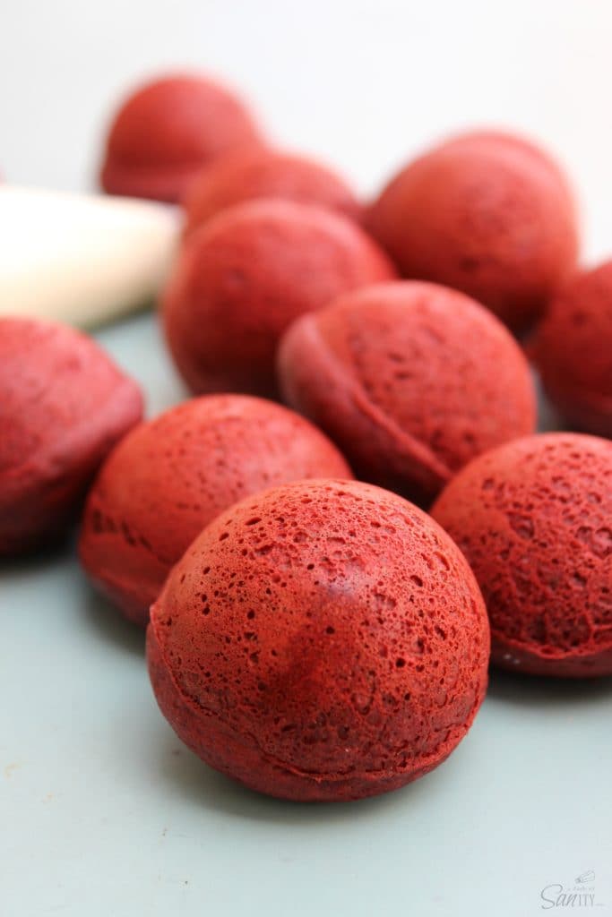 Baked Red Velvet Cake Donuts Holes are the most amazing donut you will have, EVER! Filled with Cream Cheese Buttercream and dipped in chocolate ganache. Baked Red Velvet Cake Donuts Holes