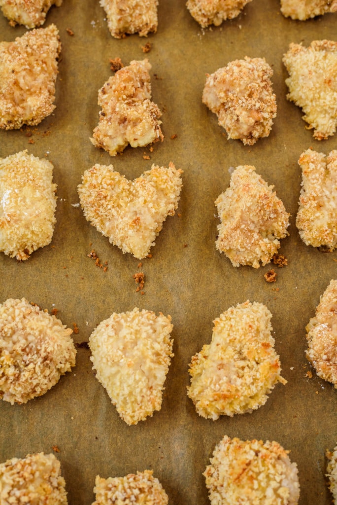 photo of crispy baked chicken pieces on a baking sheet