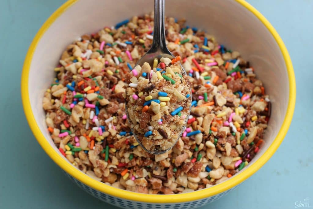 Copycat Dairy Queen Crunch Cone aka "Crunch Coat" recipe is the best ice cream topping you will ever have! Time to move over hot fudge. bowl of crunch cone topping in a bowl with spoonful of topping up close