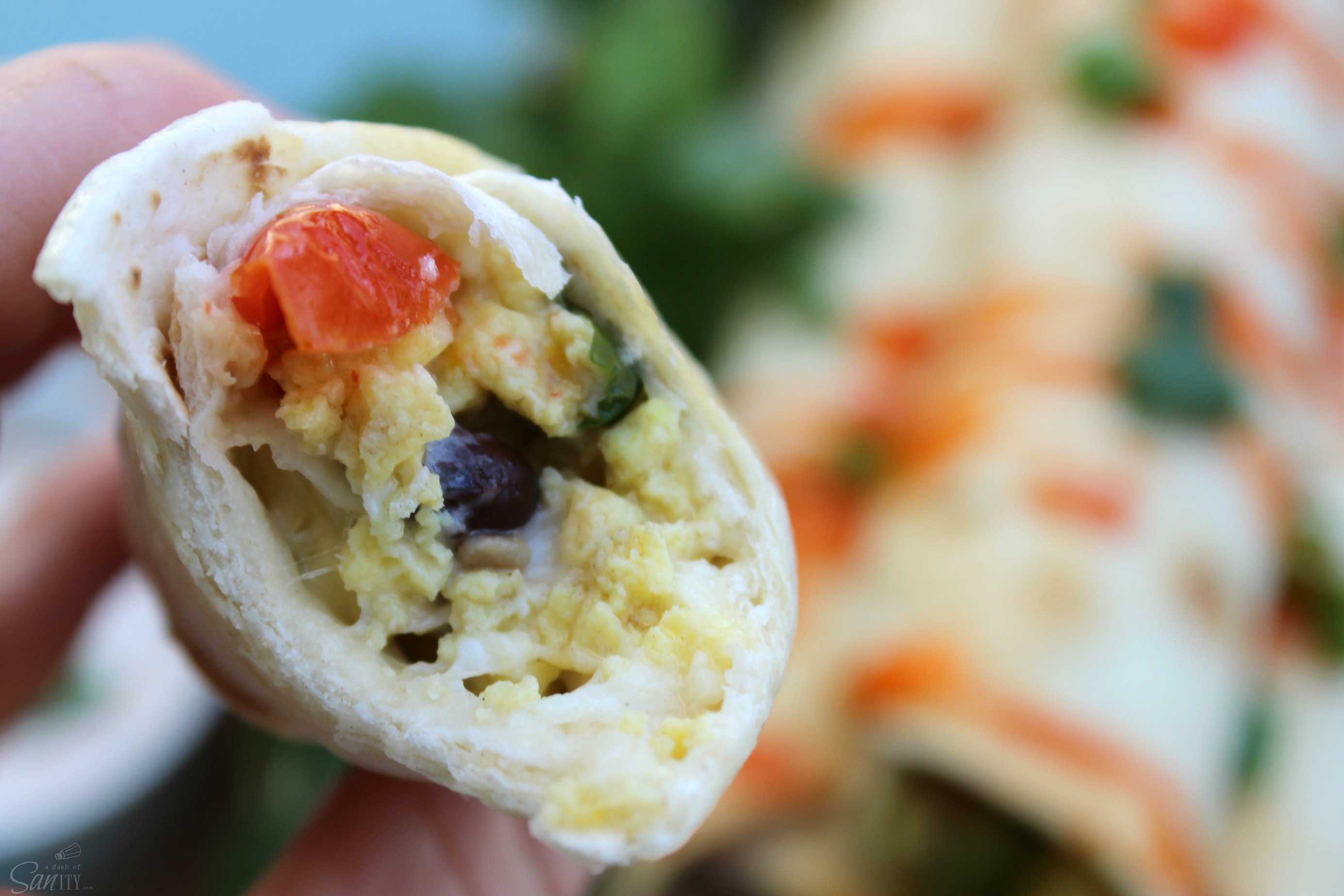 These Santa Fe Breakfast Taquitos are loaded with eggs, breakfast sausage, fresh peppers, tomatoes, cilantro, & jalapeno for those who like a little heat.