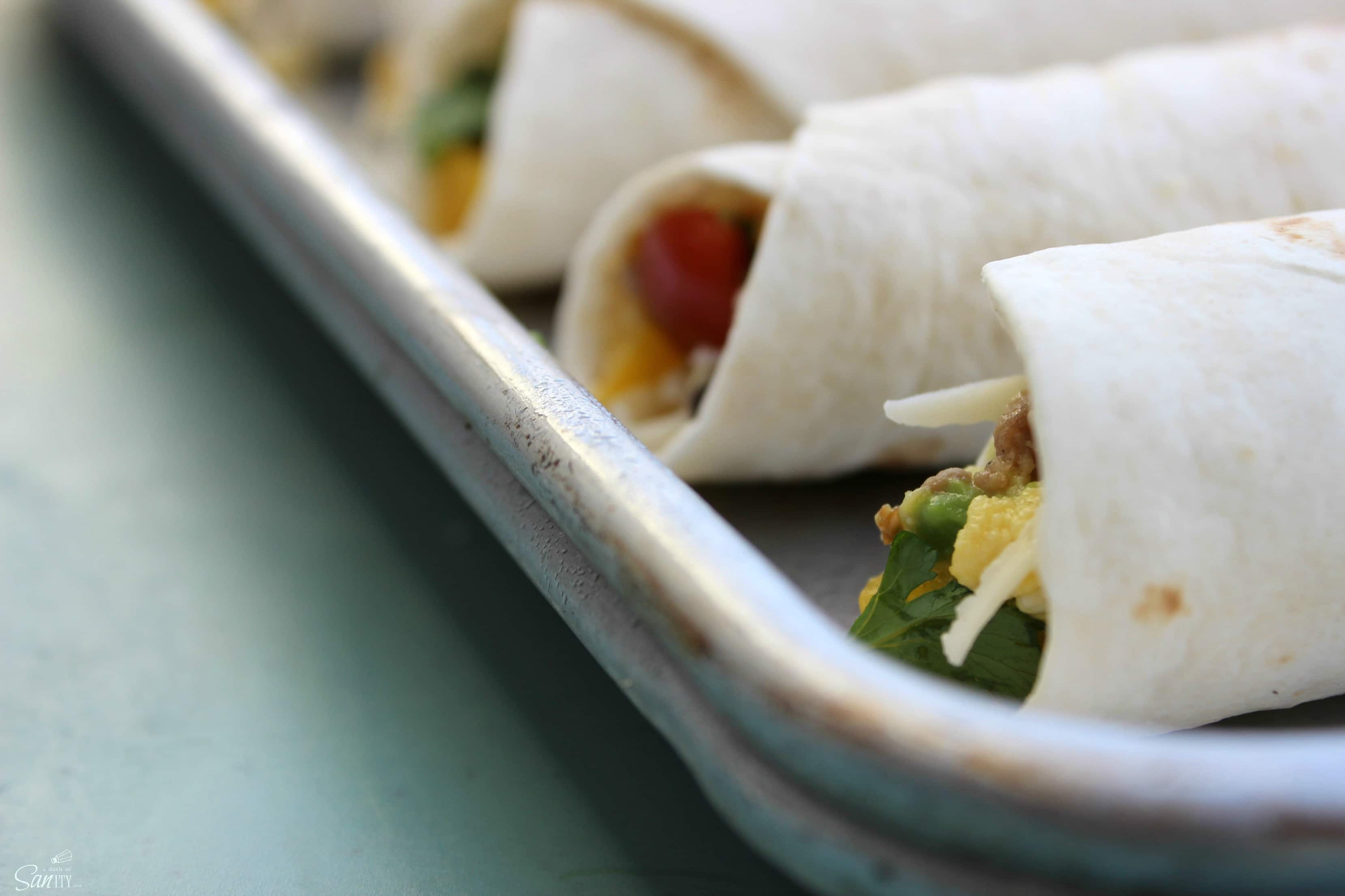 These Santa Fe Breakfast Taquitos are loaded with eggs, breakfast sausage, fresh peppers, tomatoes, cilantro, & jalapeno for those who like a little heat.