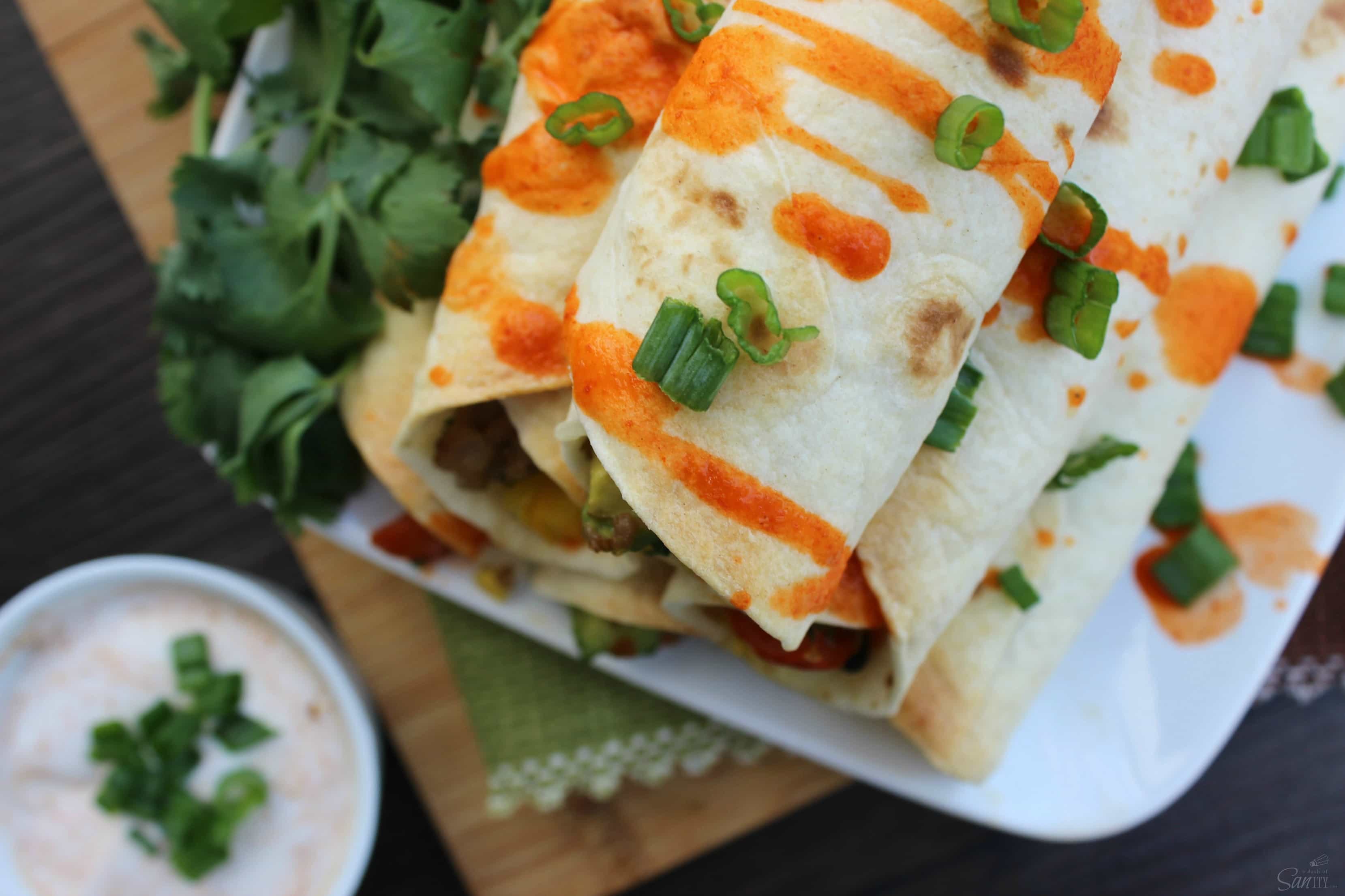 These Santa Fe Breakfast Taquitos are loaded with eggs, breakfast sausage, fresh peppers, tomatoes, cilantro, & jalapeno for those who like a little heat.