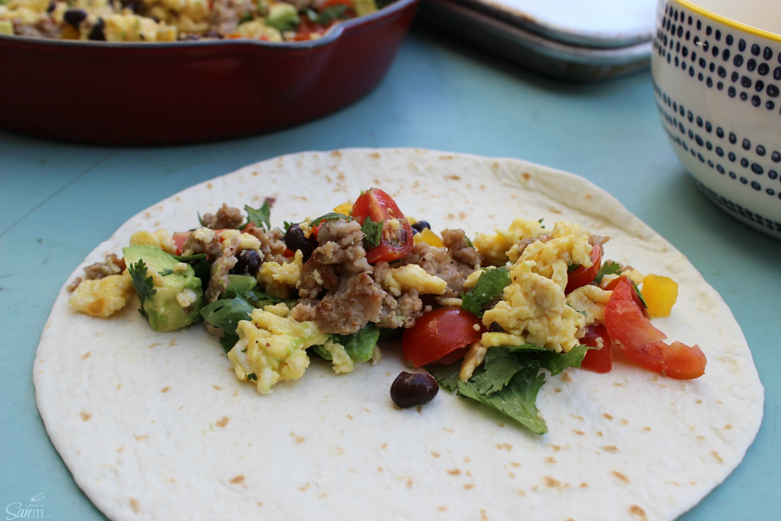 These Santa Fe Breakfast Taquitos are loaded with eggs, breakfast sausage, fresh peppers, tomatoes, cilantro, & jalapeno for those who like a little heat.
