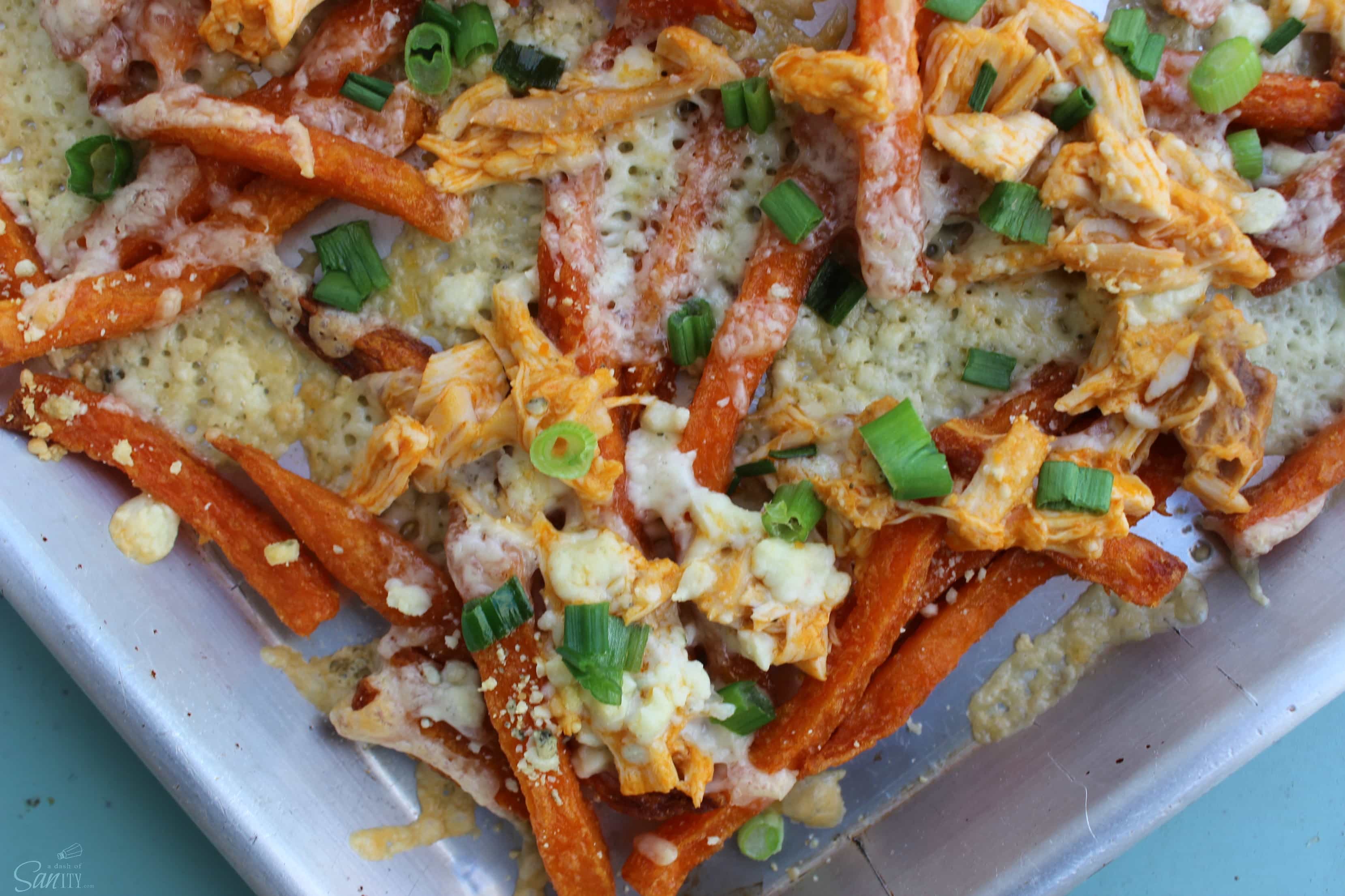 Buffalo Chicken Fries are like a buffalo chicken wing, but in a single bite- gooey cheese, chicken, buffalo sauce, topped with blue cheese and green onions.