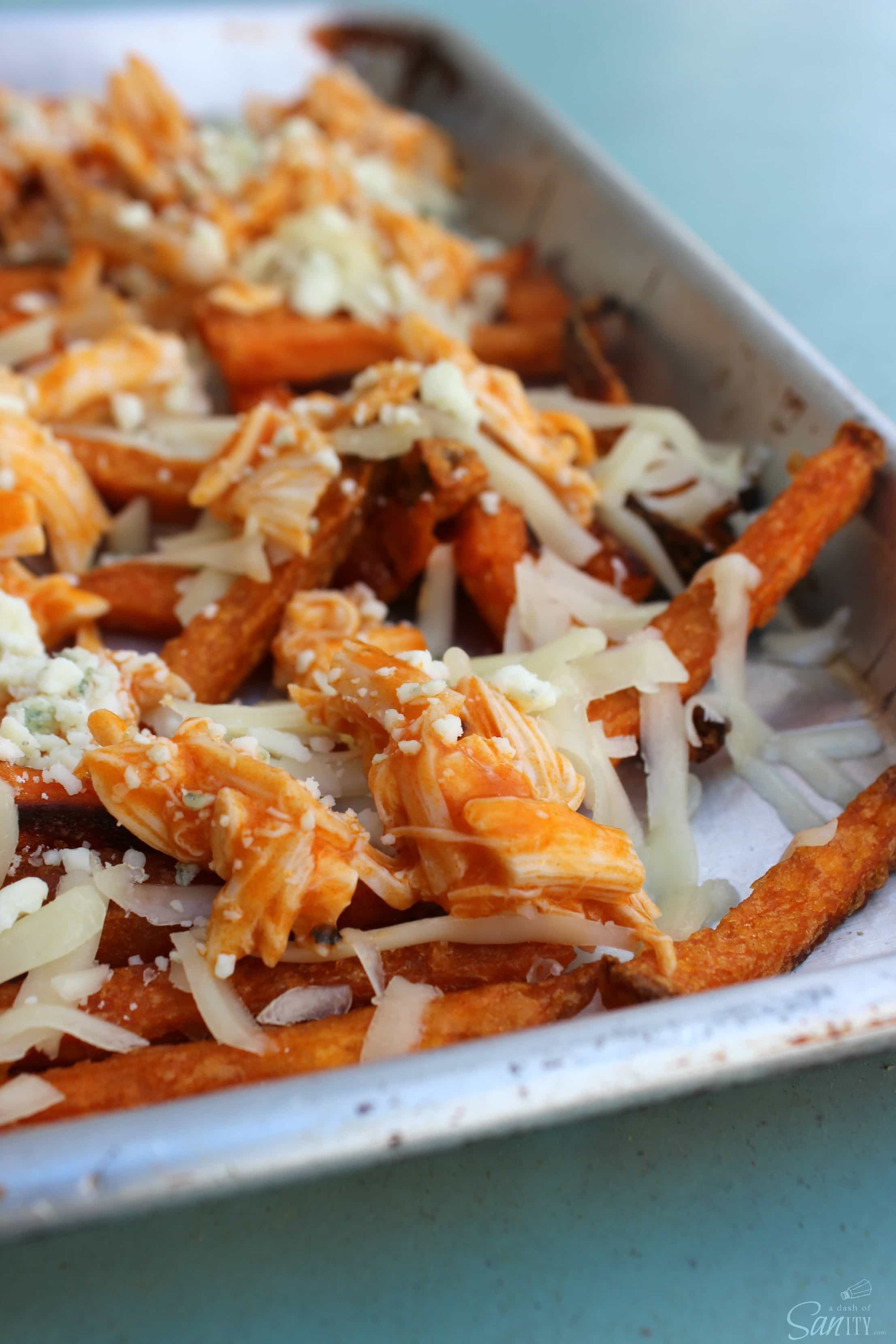 Buffalo Chicken Fries are like a buffalo chicken wing, but in a single bite- gooey cheese, chicken, buffalo sauce, topped with blue cheese and green onions.