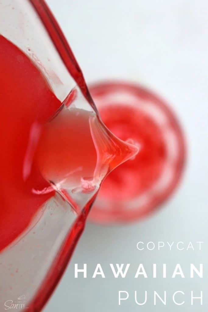 Copycat Hawaiian Punch in a glass pitcher being poured into a glass cup