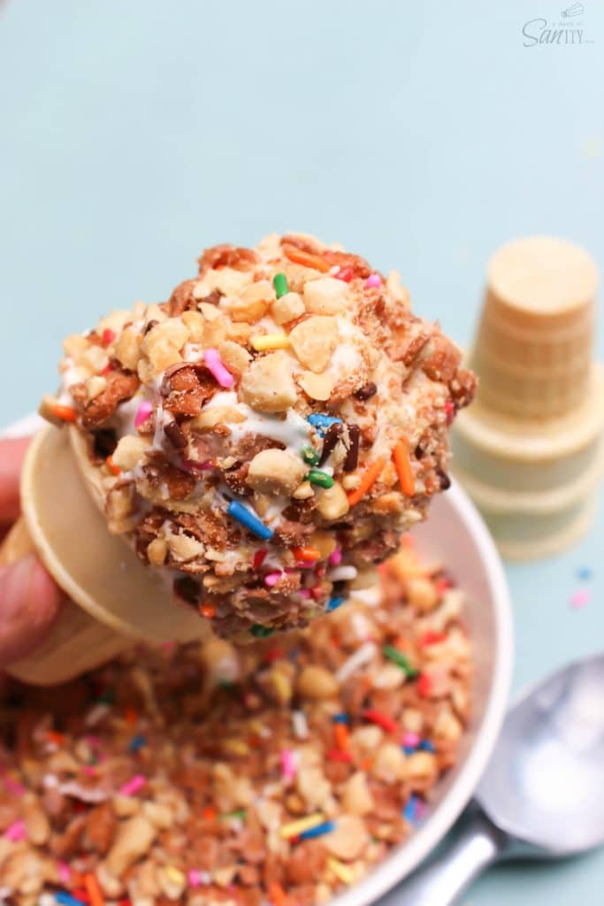 Copycat Dairy Queen Crunch Cone aka "Crunch Coat" recipe is the best ice cream topping you will ever have! Time to move over hot fudge. photo of Copycat Dairy Queen Crunch Cone, above bowl of crunch coat topping