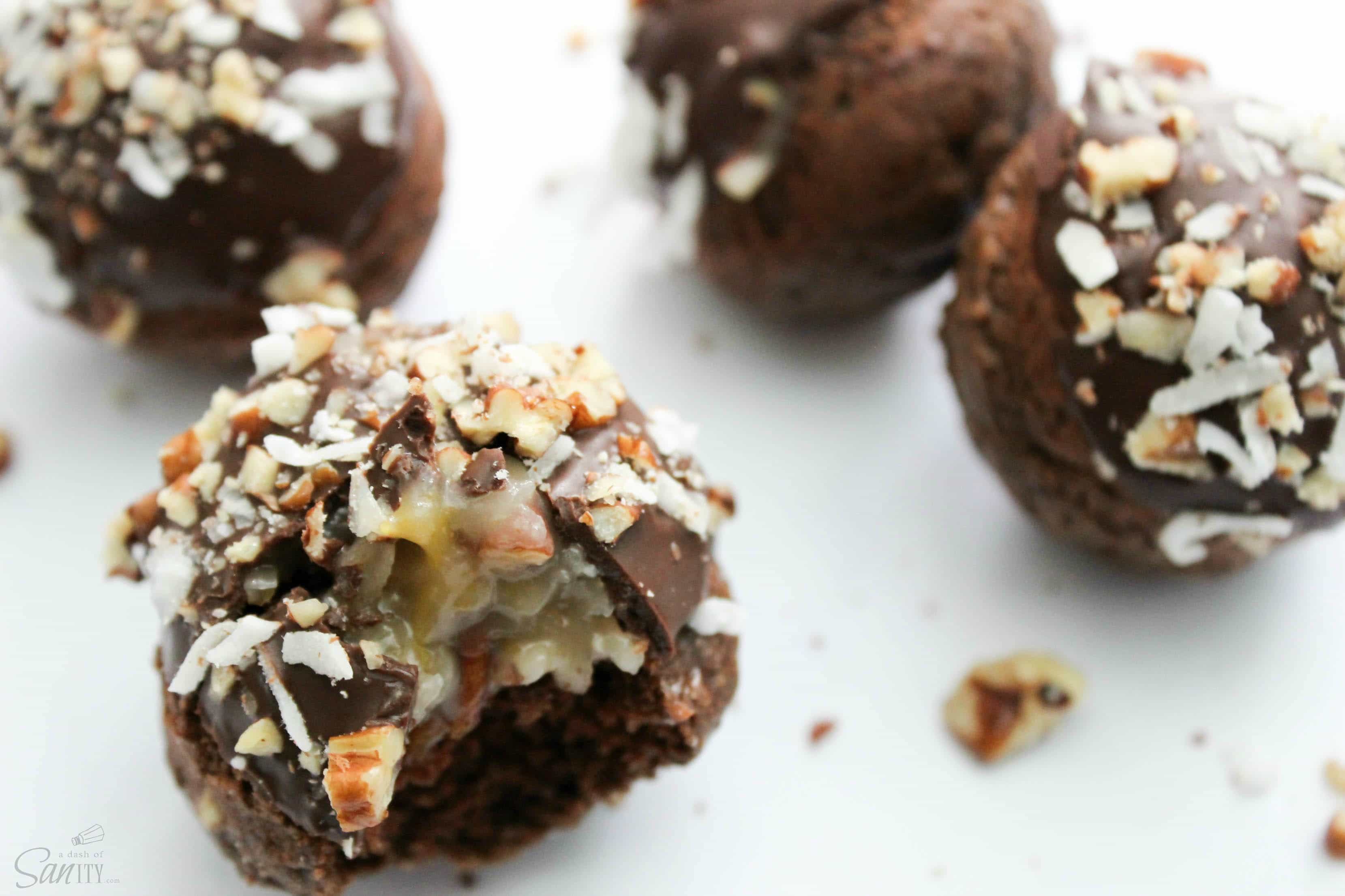 These German Chocolate Cake Donut Holes chocolate are filled with a German Chocolate frosting, then dipped in chocolate and topped with pecans and coconut. 