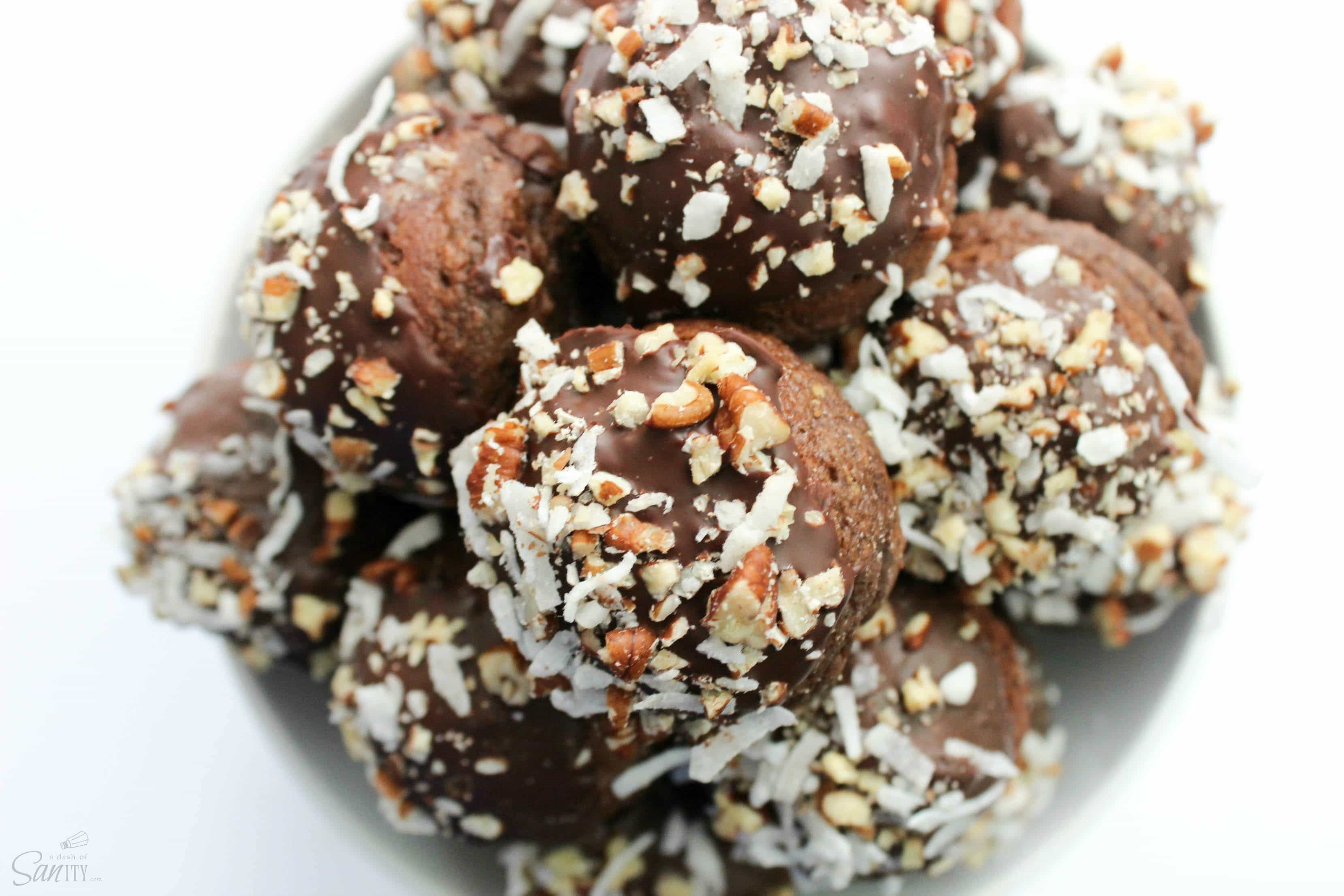 These German Chocolate Cake Donut Holes chocolate are filled with a German Chocolate frosting, then dipped in chocolate and topped with pecans and coconut. 