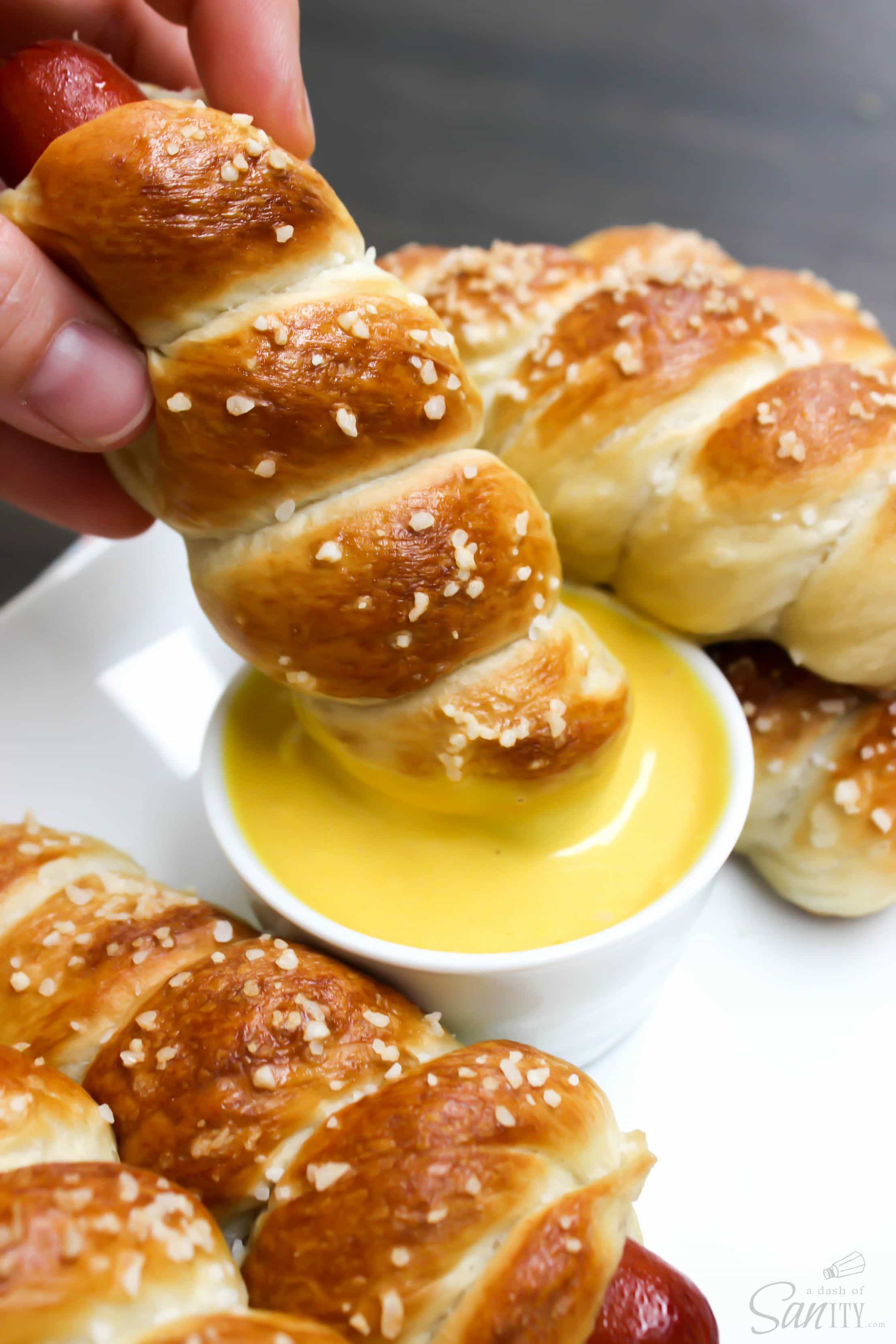 pretzel dog dipped in sauce
