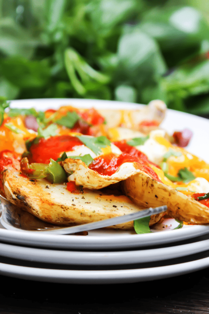 COLORADO BREAKFAST HASH flavorful, vibrant and easy, this super simple meal won’t be made just for breakfast but for lunch and dinner as well. up close breakfast hash with hash browns, eggs, cilantro and sauce on a stack of 3 white plates