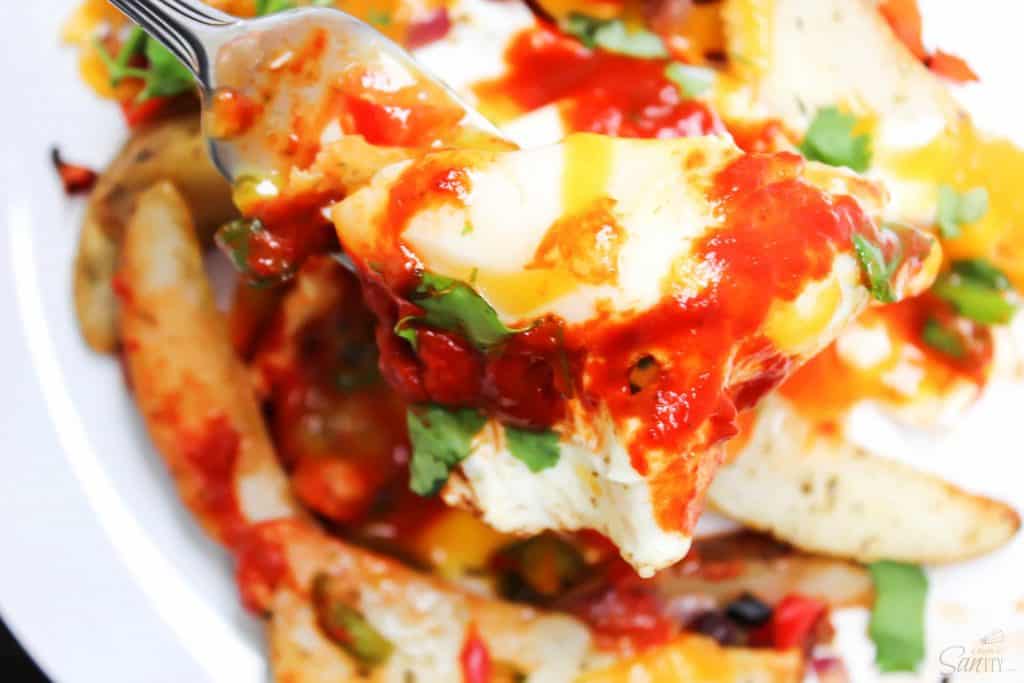 COLORADO BREAKFAST HASH flavorful, vibrant and easy, this super simple meal won’t be made just for breakfast but for lunch and dinner as well. breakfast hash with colorado chile sauce on white plate, up close bite on a fork