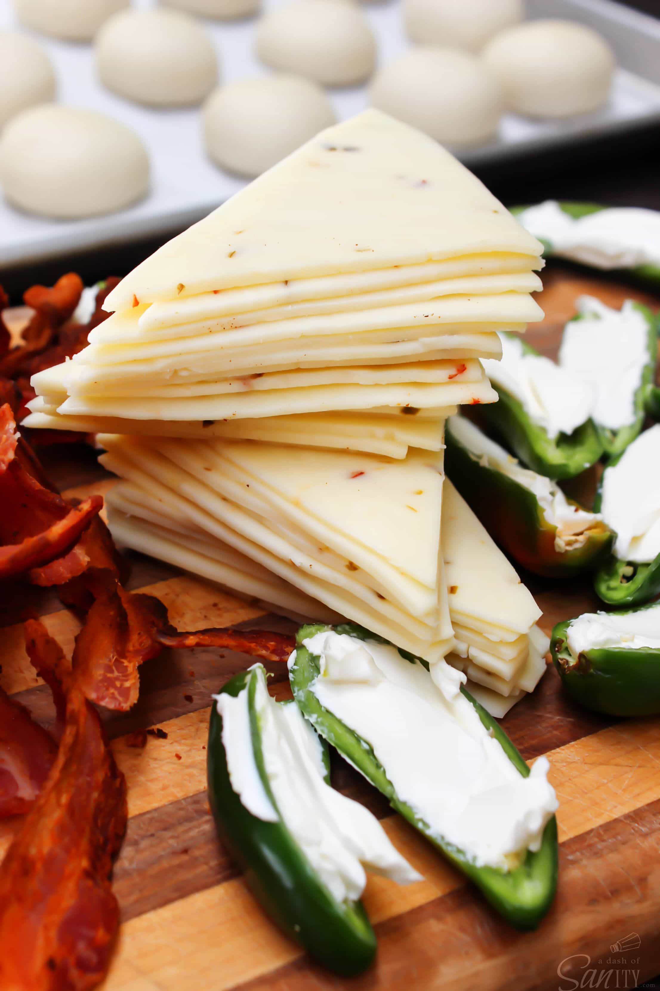 Jalapeño Poppers with cheese, more cheese, bacon, & jalapenos wrapped up in a soft roll, what on earth could be better than that? Oh yeah, more cheese.