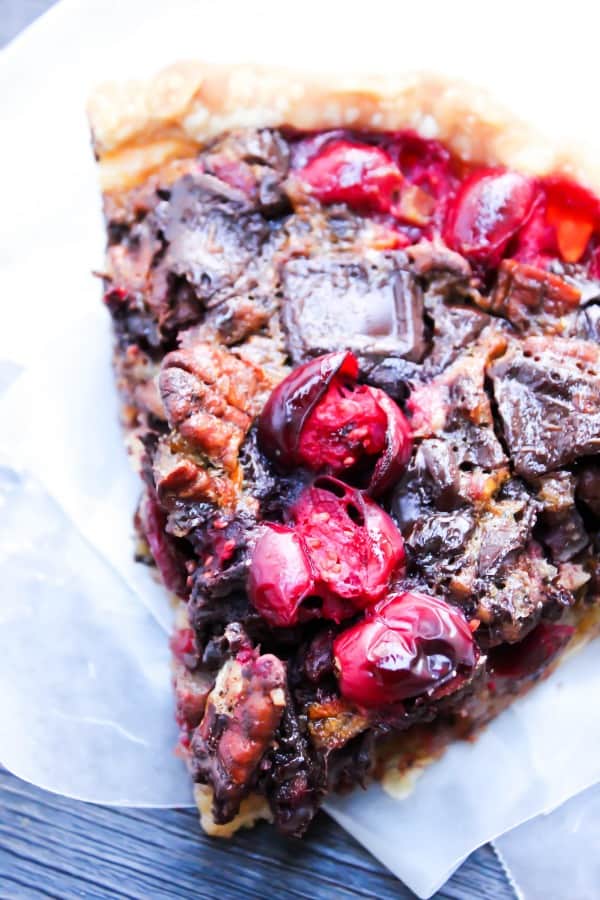 Chocolate Pecan Cranberry Pie a sweet addition to your dessert table. Made with pecans & cranberries it has traditional holiday flavors but with a twist. Chocolate Pecan Cranberry Pie slice