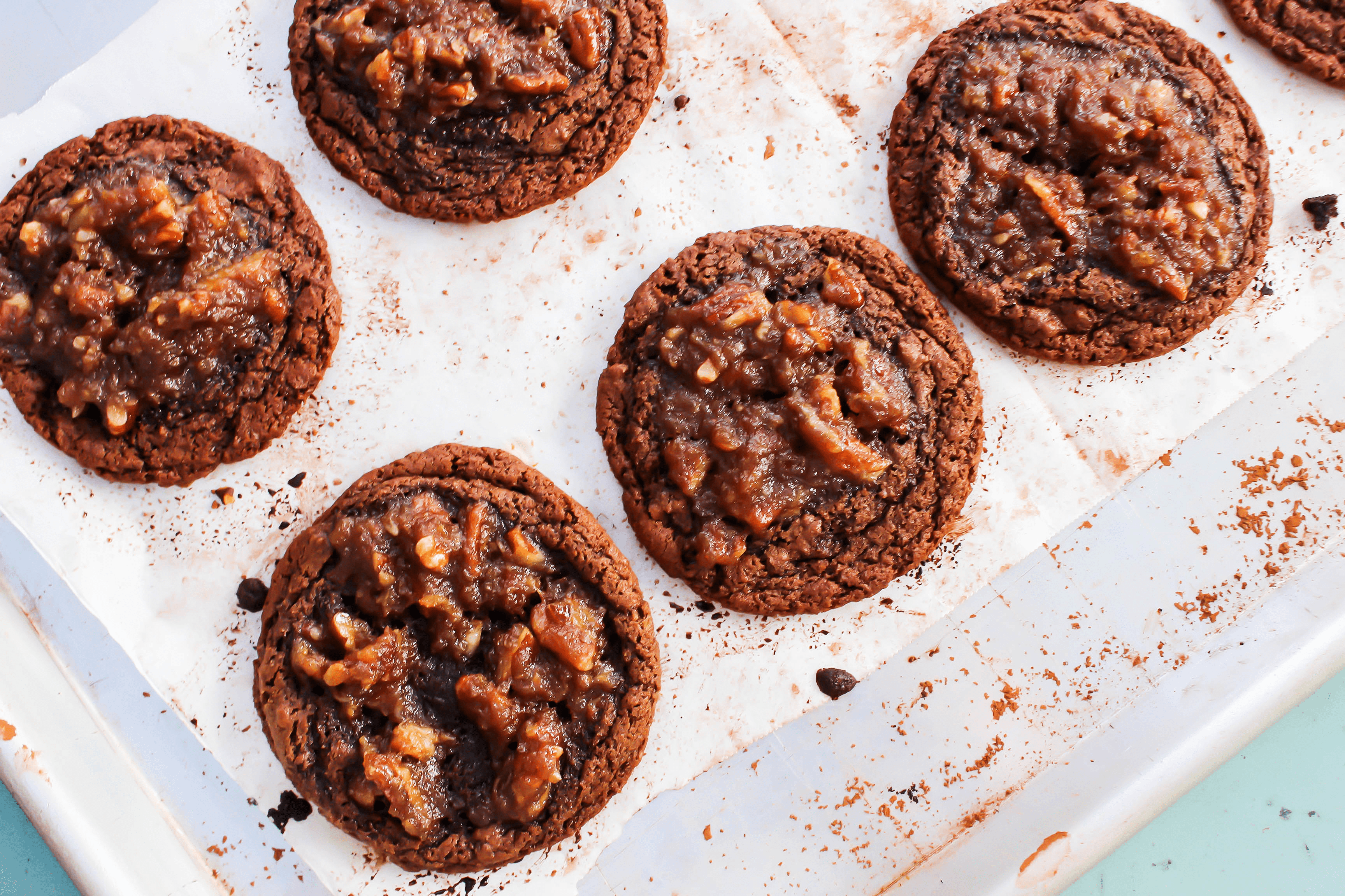 These Chocolate Pecan Pie Cookies are a delicious soft and chewy chocolate cookie with a classic pecan pie filling baked into the center.