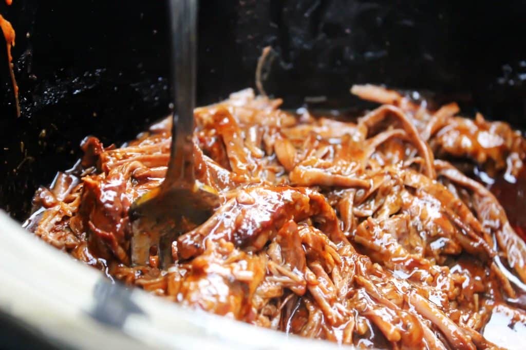photo showing fork shredding Easy Barbecue Beef Brisket in slow cooker