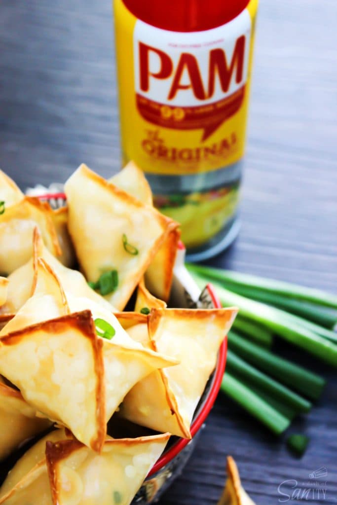 Baked Chicken Wontons are a healthier version of the classic cream-cheese wonton, with a chicken filling flavored with sesame, green onions and sriracha.