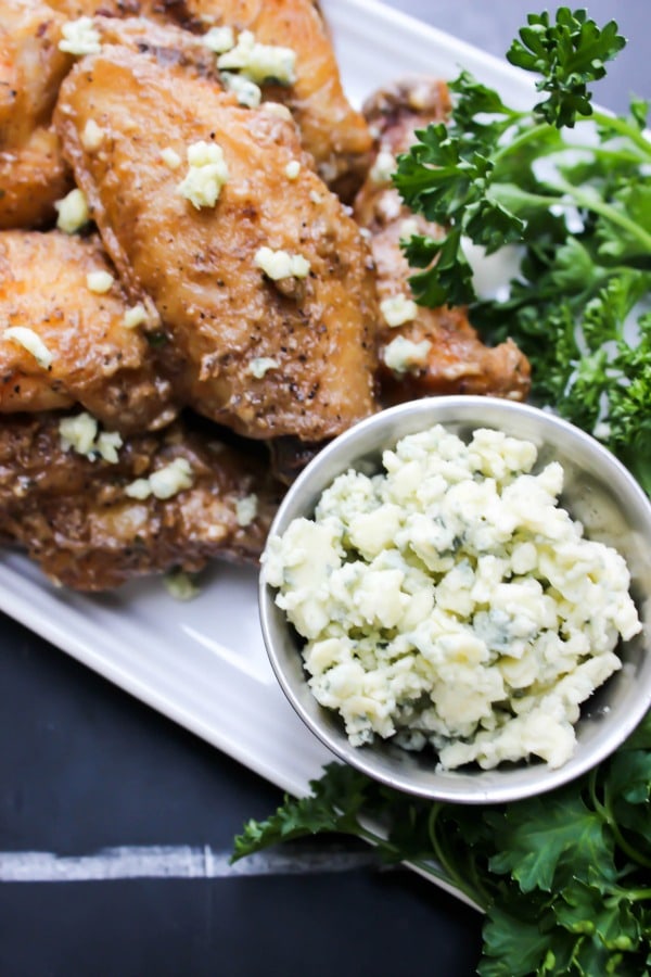 Black and Blue Chicken Wings are tossed in a blue cheese vinaigrette, pepper, three kinds of garlic, & crumbled blue cheese. This isn’t a wing for the weak.