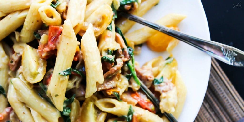 Creamy "BLT" Pasta is a twist on a traditional BLT. Made with bacon, roasted tomatoes, and spinach, this will have you craving a BLT every single night.