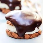 ding dong cookie with parchment paper underneath, cookie topped with ganche