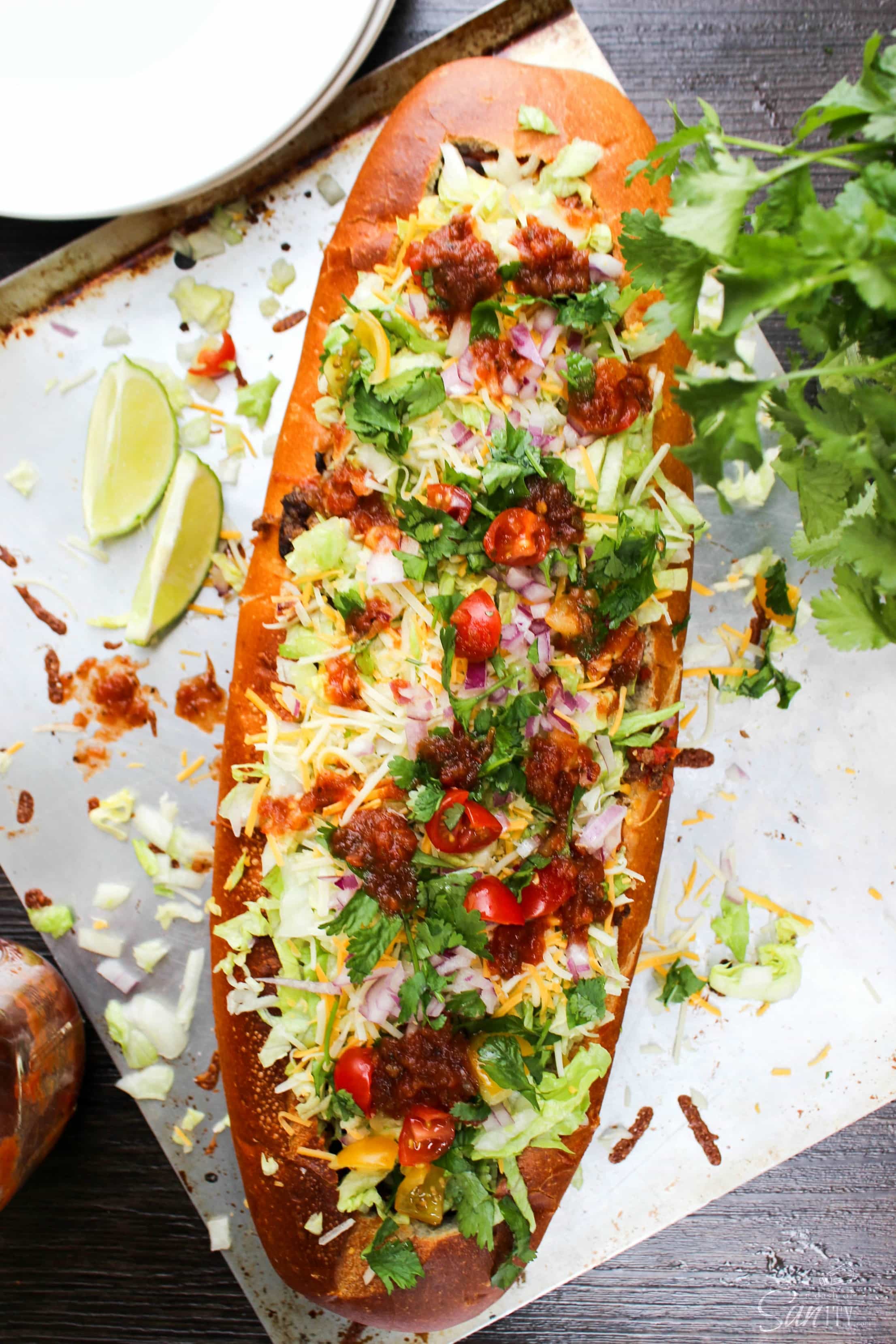 Stuffed Taco Bread is made from your favorite taco ingredients, stuffed into a warm loaf of bread. Cheesy, easy, and made with fresh ingredients.