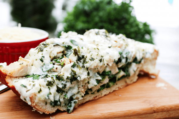 slice of french bread stuff with chicken cheese and spinach
