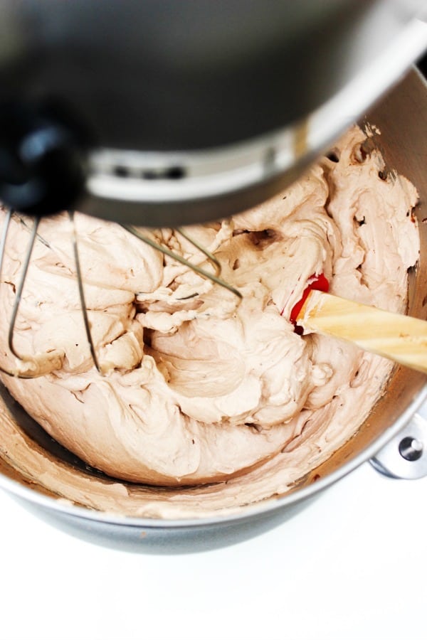 Chocolate Whipped Cream in the metal bowl of a stand mixer with a whisk attachment