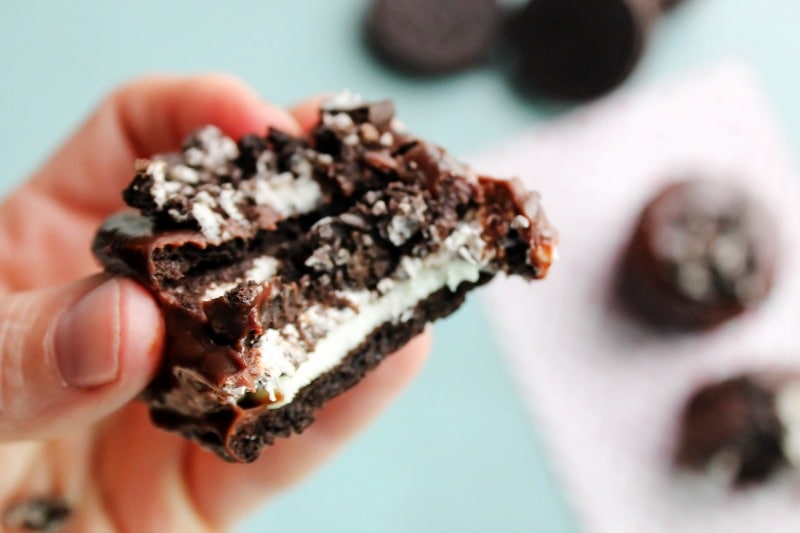 close up shot Mini Oreo No-Bake Cheesecakes with bite out of one