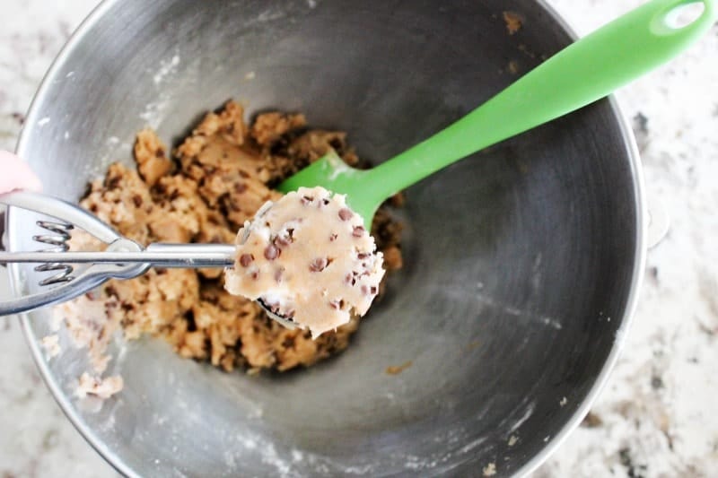 Insanely delicious and fun for summer these Chocolate Chip Cookie Dough Ice Cream Bites are bite-sized ice cream wrapped in chocolate chip cookie dough. Chocolate Chip Cookie Dough Ice Cream Bite assembled in cookie scoop