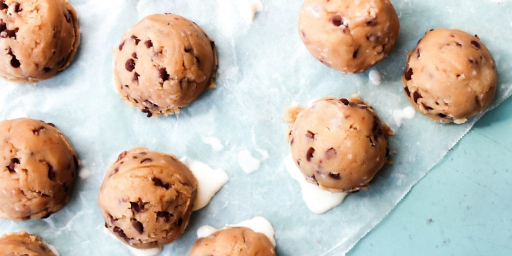 Insanely delicious and fun for summer these Chocolate Chip Cookie Dough Ice Cream Bites are bite-sized ice cream wrapped in chocolate chip cookie dough. Chocolate Chip Cookies Dough Ice Cream Bites on wax paper