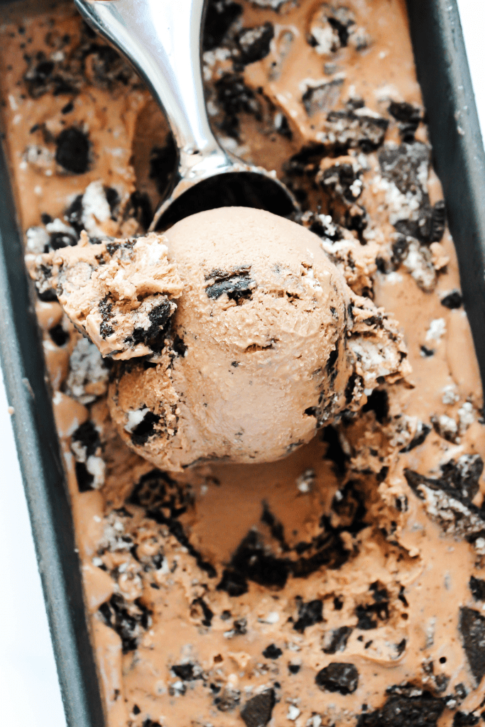 COOKIES & CREAM NUTELLA ICE CREAM - Creamy and rich, this chocolate Nutella ice cream with Oreo chunks makes for a mouthwatering combination overhead photo of a scoop of ice cream in a metal baking pan