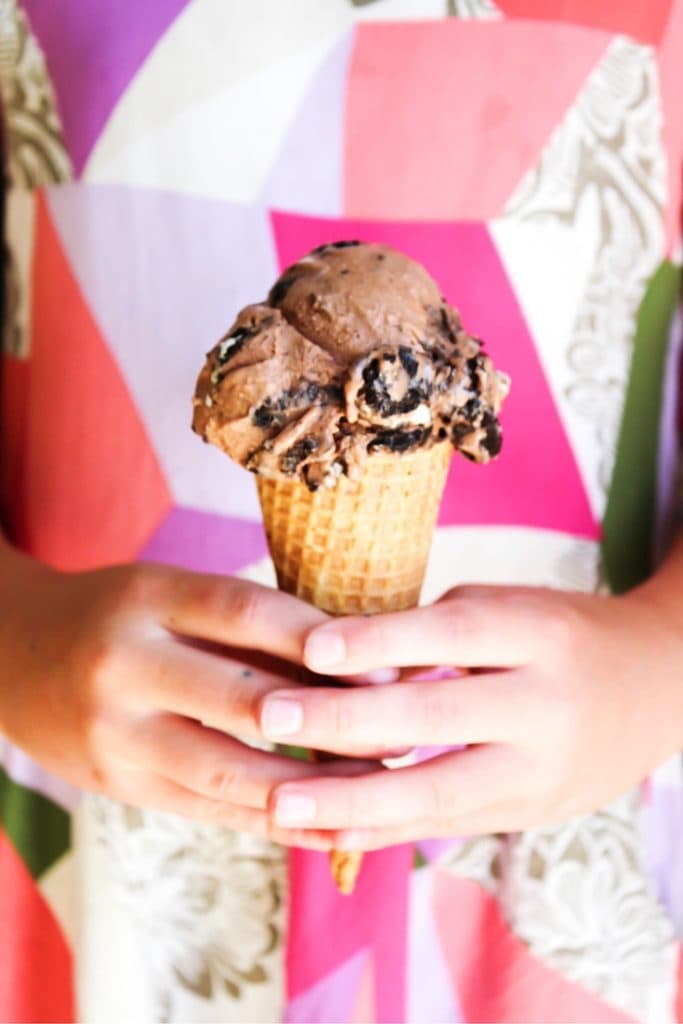 photo of a child holding an ice cream cone with 1 scoop of nutella ice cream